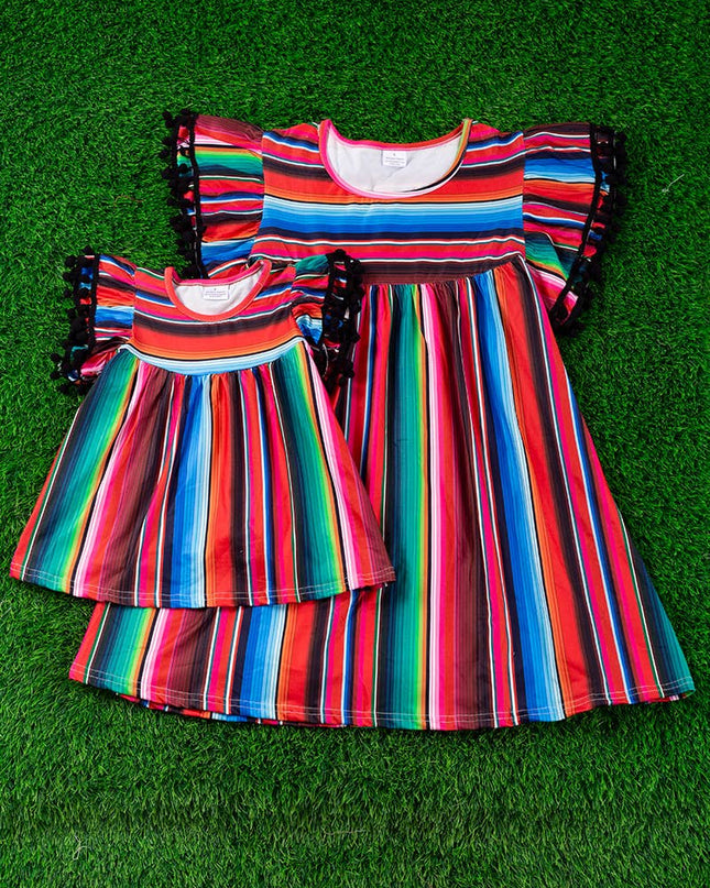 SERAPE PRINTED TUNIC WITH BLACK POM POM TRIM. TPG15113017-SO