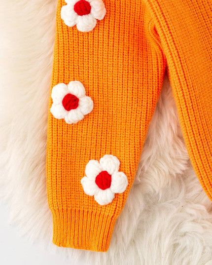 Orange Thankful knit sweater with embroidered flowers on sleeves.